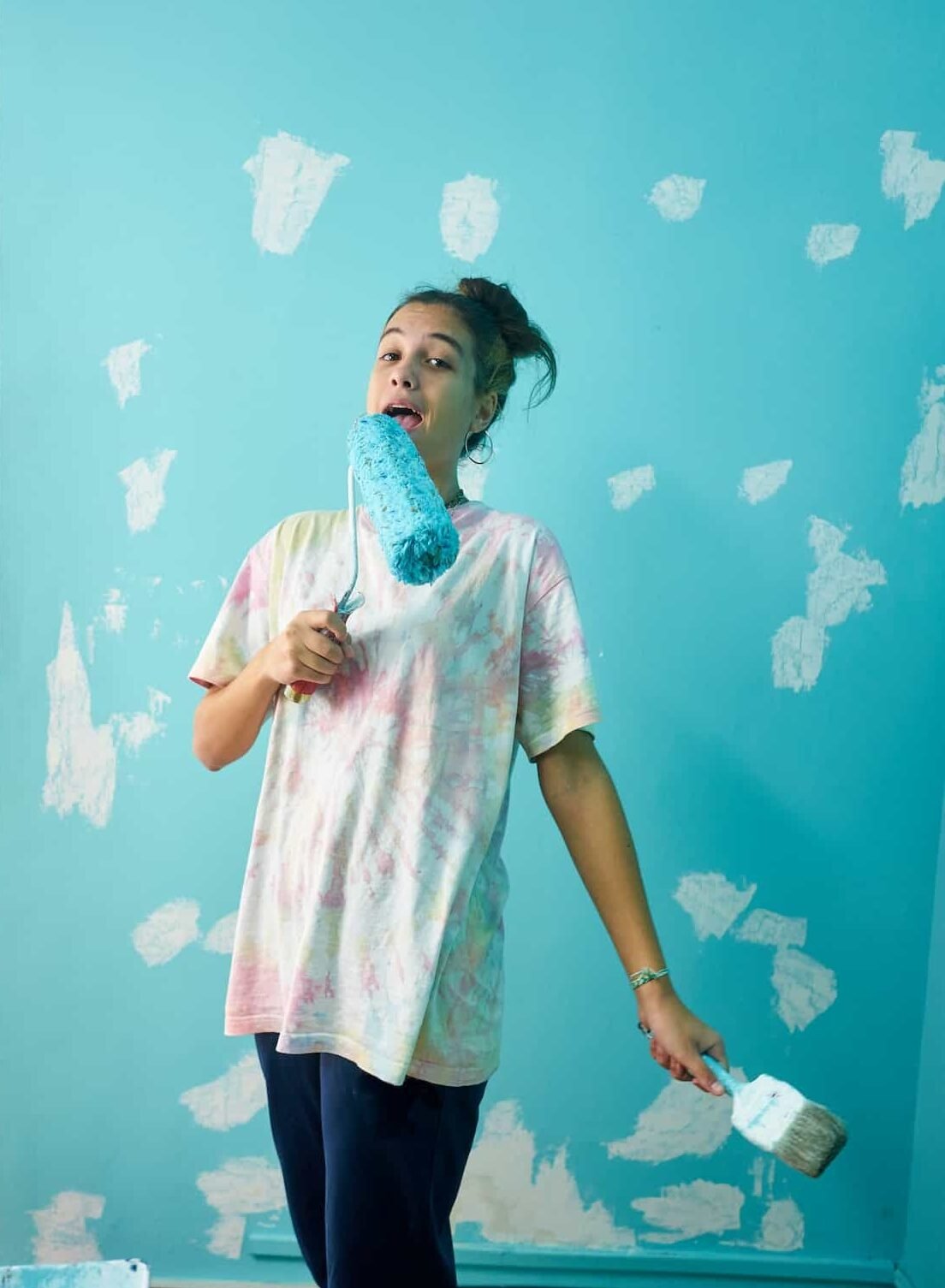 happy-woman-painting-interior-wall-with-paint-roller-in-new-house-e1678323493469.jpg
